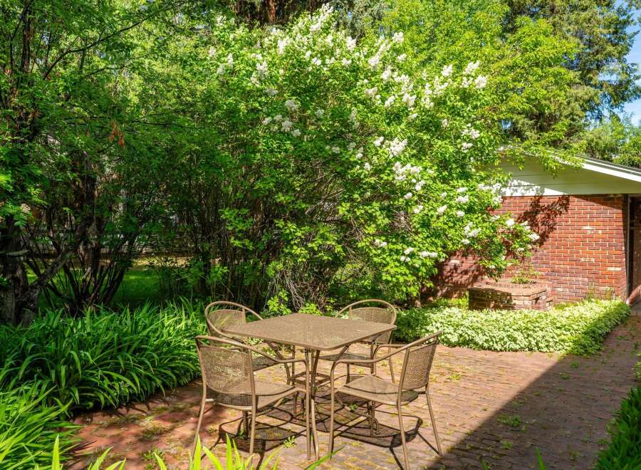 Enjoy outdoor dining in this charming brick patio area, perfect for al fresco meals.