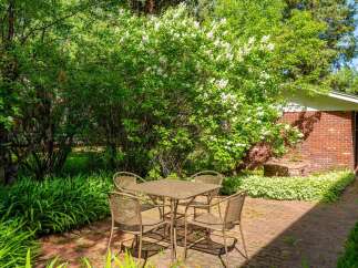 Enjoy outdoor dining in this charming brick patio area, perfect for al fresco meals.