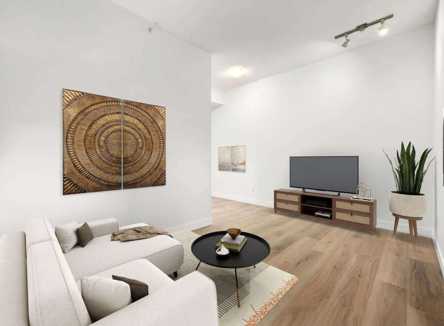 Experience modern living in this beautifully staged living room, featuring a plush sectional sofa perfect for relaxation and entertainment.