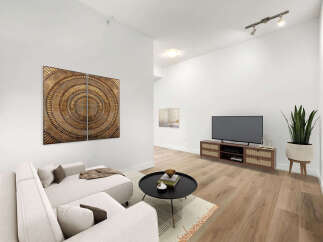 Experience modern living in this beautifully staged living room, featuring a plush sectional sofa perfect for relaxation and entertainment.