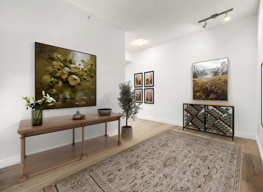 Step into this elegant entryway, featuring a stunning floral still life painting above a sleek wooden console table adorned with fresh lilies.