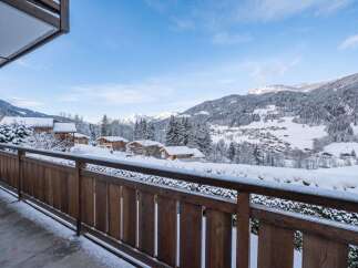 Experience the charm of a winter wonderland from this stunning balcony view.
