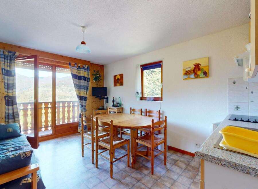 Enjoy breathtaking mountain views from this charming apartment, featuring a cozy living area with a sofa bed and a dining space perfect for family meals.