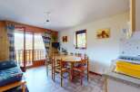 Enjoy breathtaking mountain views from this charming apartment, featuring a cozy living area with a sofa bed and a dining space perfect for family meals.