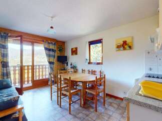 Enjoy breathtaking mountain views from this charming apartment, featuring a cozy living area with a sofa bed and a dining space perfect for family meals.