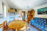 This charming studio apartment features a well-equipped kitchenette and a cozy dining area perfect for meals.