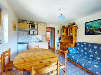 This charming studio apartment features a well-equipped kitchenette and a cozy dining area perfect for meals.