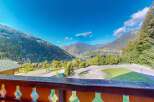 Experience breathtaking mountain views from this property, offering a serene escape amidst lush greenery and majestic peaks.
