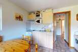 This charming kitchen features a compact dining area with a wooden table and chairs, perfect for intimate meals.