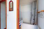Step into this charming bathroom featuring a clean white bathtub and shower area, perfect for relaxation.