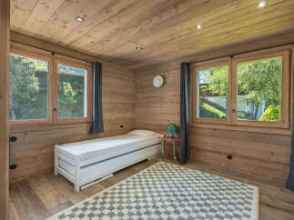 This charming bedroom features a cozy twin bed with a pull-out trundle, perfect for guests.