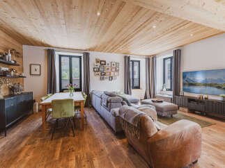 Experience rustic charm and modern comfort in this beautifully appointed living and dining area.