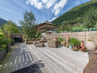 Enjoy breathtaking mountain views from this stunning wooden deck, perfect for outdoor entertaining.