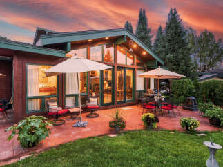 Experience luxurious outdoor living with this stunning patio featuring comfortable seating, a dining set, and a grill, perfect for entertaining.