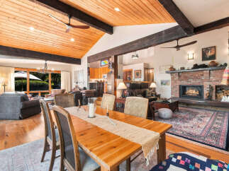 Experience rustic charm and modern comfort in this spacious living and dining area.