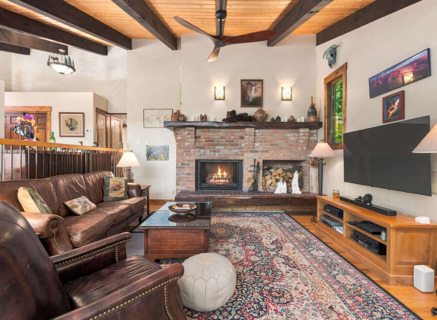 Experience rustic charm in this inviting living room, featuring a grand brick fireplace as the centerpiece.