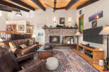 Experience rustic charm in this inviting living room, featuring a grand brick fireplace as the centerpiece.