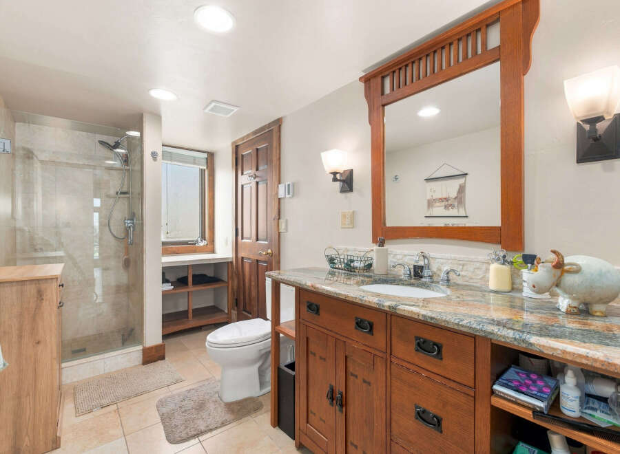 This charming bathroom features a spacious walk-in shower with elegant tilework and a modern showerhead.
