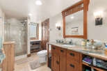 This charming bathroom features a spacious walk-in shower with elegant tilework and a modern showerhead.
