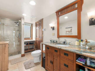 This charming bathroom features a spacious walk-in shower with elegant tilework and a modern showerhead.
