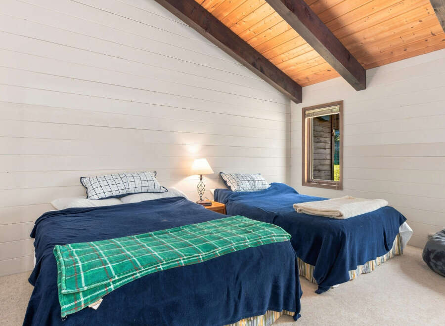 This charming bedroom features two cozy twin beds, perfect for guests or family.