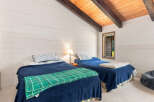 This charming bedroom features two cozy twin beds, perfect for guests or family.