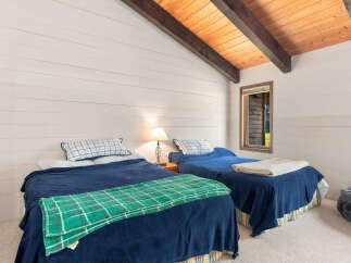 This charming bedroom features two cozy twin beds, perfect for guests or family.