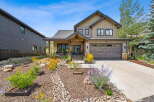 Discover this stunning modern mountain home featuring a welcoming covered porch and a spacious two-car garage.