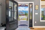 Step into this stunning mountain home through a grand, open-concept entryway that offers breathtaking views of the surrounding peaks.