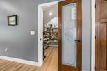 Step into this charming pantry, featuring a frosted glass door with a decorative etched design.