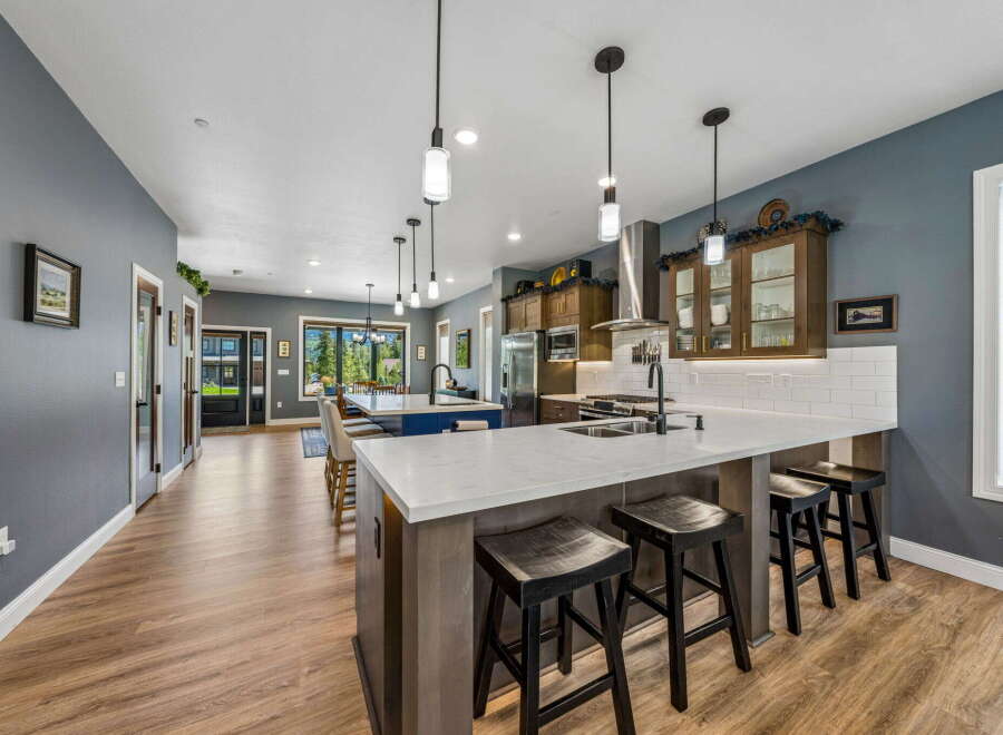 Experience luxury and comfort in this stunning kitchen, featuring a spacious island with ample seating and a sleek, modern design.