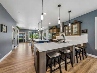 Experience luxury and comfort in this stunning kitchen, featuring a spacious island with ample seating and a sleek, modern design.