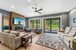 Experience modern living in this spacious living room, featuring a sleek fireplace and a large flat-screen TV perfect for entertainment.