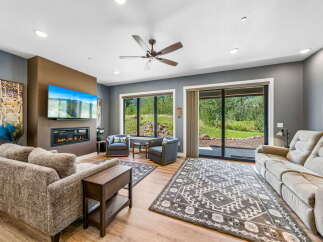 Experience modern living in this spacious living room, featuring a sleek fireplace and a large flat-screen TV perfect for entertainment.
