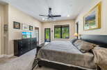 Experience ultimate comfort in this spacious bedroom, featuring a plush king-sized bed adorned with a luxurious quilted comforter.