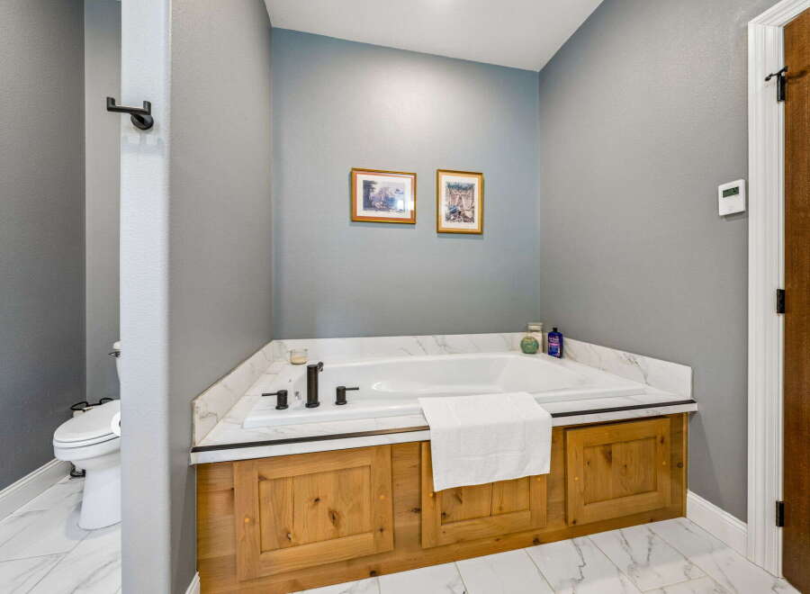 Indulge in relaxation in this luxurious bathroom featuring a spacious soaking tub, perfect for unwinding after a long day.