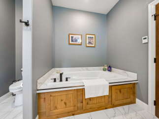 Indulge in relaxation in this luxurious bathroom featuring a spacious soaking tub, perfect for unwinding after a long day.