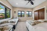 Experience breathtaking mountain views from this spacious bedroom, featuring two comfortable twin beds and a queen-sized bed, perfect for families or groups.