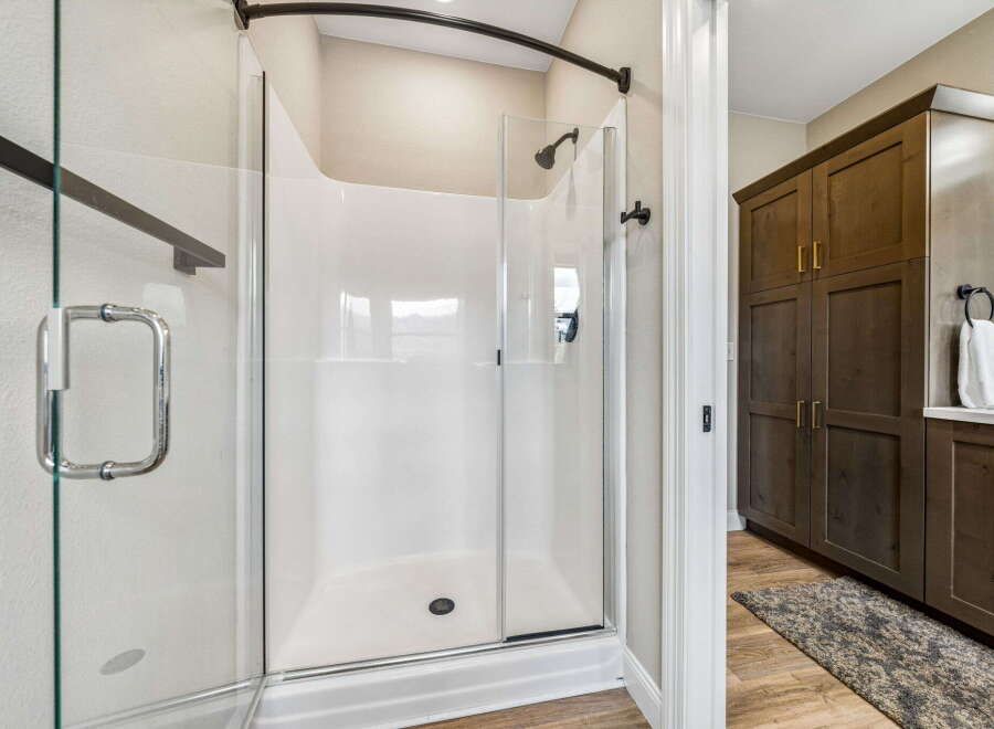 Step into this beautifully appointed bathroom featuring a spacious, modern shower with a glass enclosure and sleek fixtures.