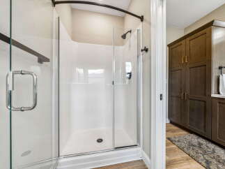 Step into this beautifully appointed bathroom featuring a spacious, modern shower with a glass enclosure and sleek fixtures.