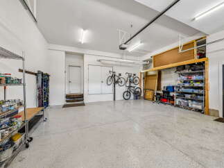 Discover ample storage and organization in this spacious garage, perfect for any homeowner.