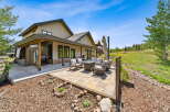 Enjoy outdoor living with this spacious patio featuring comfortable seating and a modern fire pit, perfect for gathering with loved ones.