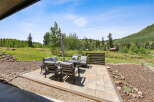 Enjoy the stunning mountain views from this beautiful patio, complete with a fire pit and comfortable seating.