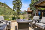 Enjoy breathtaking mountain views from this stunning outdoor living space, complete with a modern fire pit and comfortable seating.