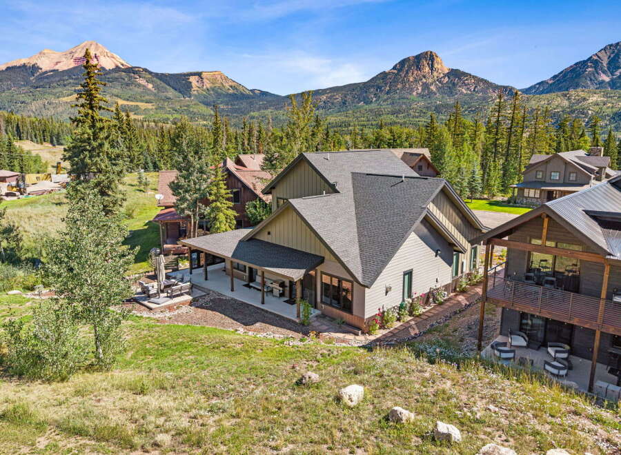 Experience mountain living in this stunning property, featuring a spacious covered patio perfect for outdoor entertaining and enjoying the breathtaking mountain views.