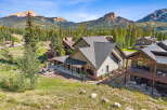 Experience mountain living in this stunning property, featuring a spacious covered patio perfect for outdoor entertaining and enjoying the breathtaking mountain views.