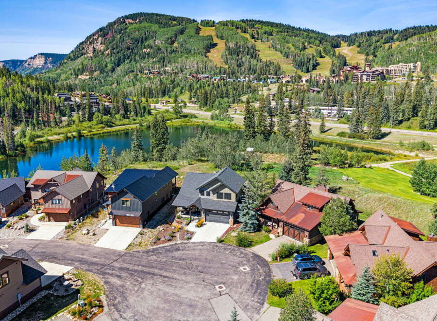 Experience luxury mountain living in this stunning property, nestled beside a serene lake with breathtaking views of ski slopes and lush forests.