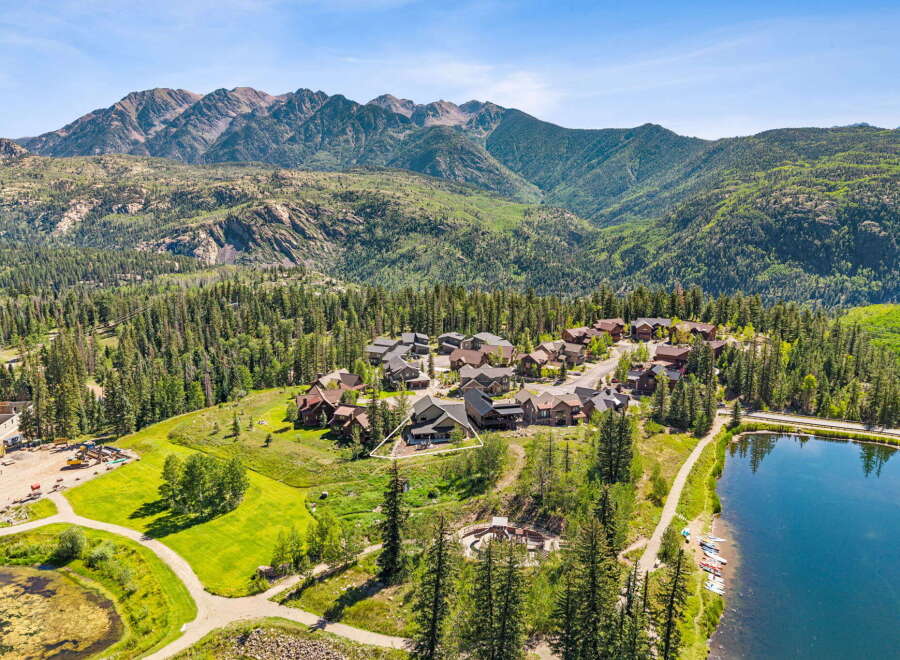 Nestled amidst a lush forest and majestic mountains, this property offers a serene escape with a beautiful lake and a charming neighborhood.