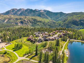 Nestled amidst a lush forest and majestic mountains, this property offers a serene escape with a beautiful lake and a charming neighborhood.
