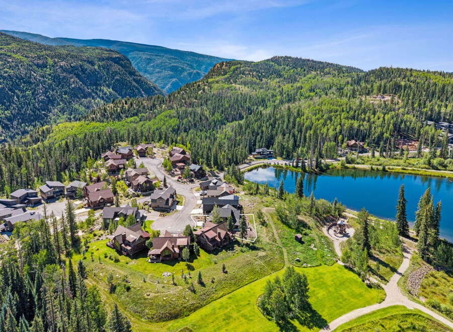 Nestled amidst a lush alpine forest, this stunning property offers breathtaking mountain views and a serene lakeside setting.
